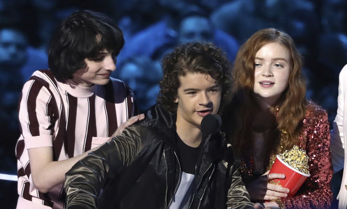 Finn Wolfhard, from left, Gaten Matarazzo and Sadie Sink accept the award for best show for “Stranger Things” at the MTV Movie and TV Awards (Photo by Matt Sayles/Invision/AP)