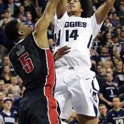 Jalen Moore (14) of Utah State goes up for a shot against Christian Wood (5) of UNLV during NCAA basketball in Logan Tuesday, Feb. 24, 2015.


