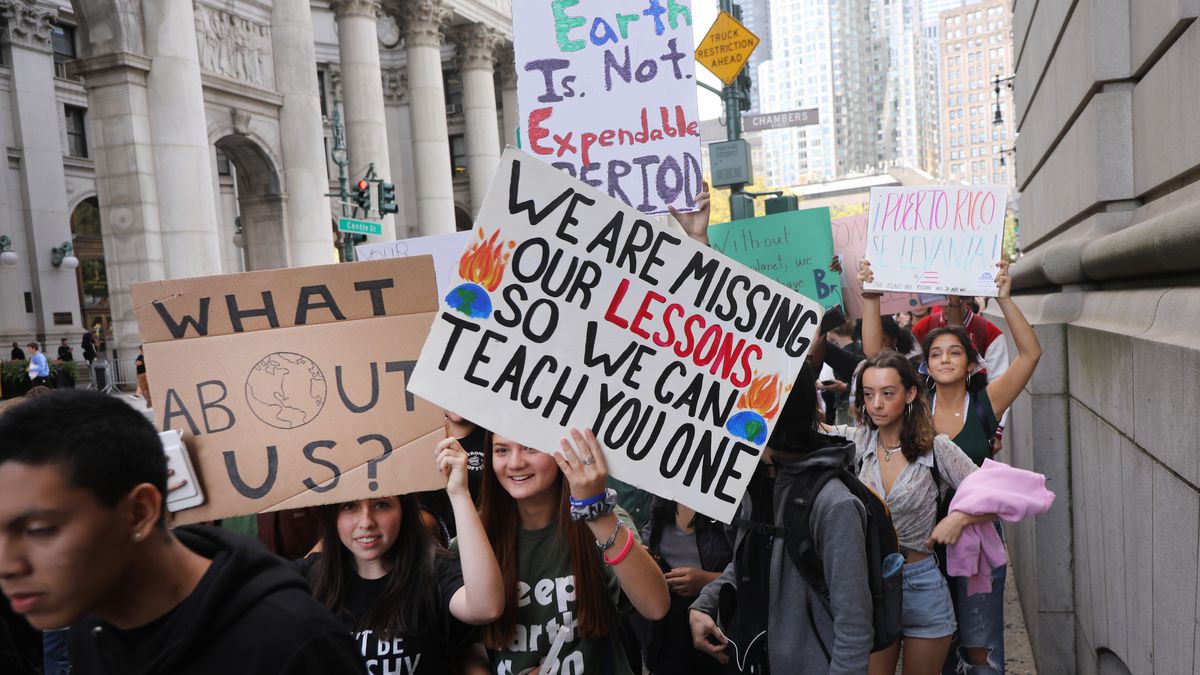 Students march through New York City clutching signs and banners in support of the Youth Climate Strike. 