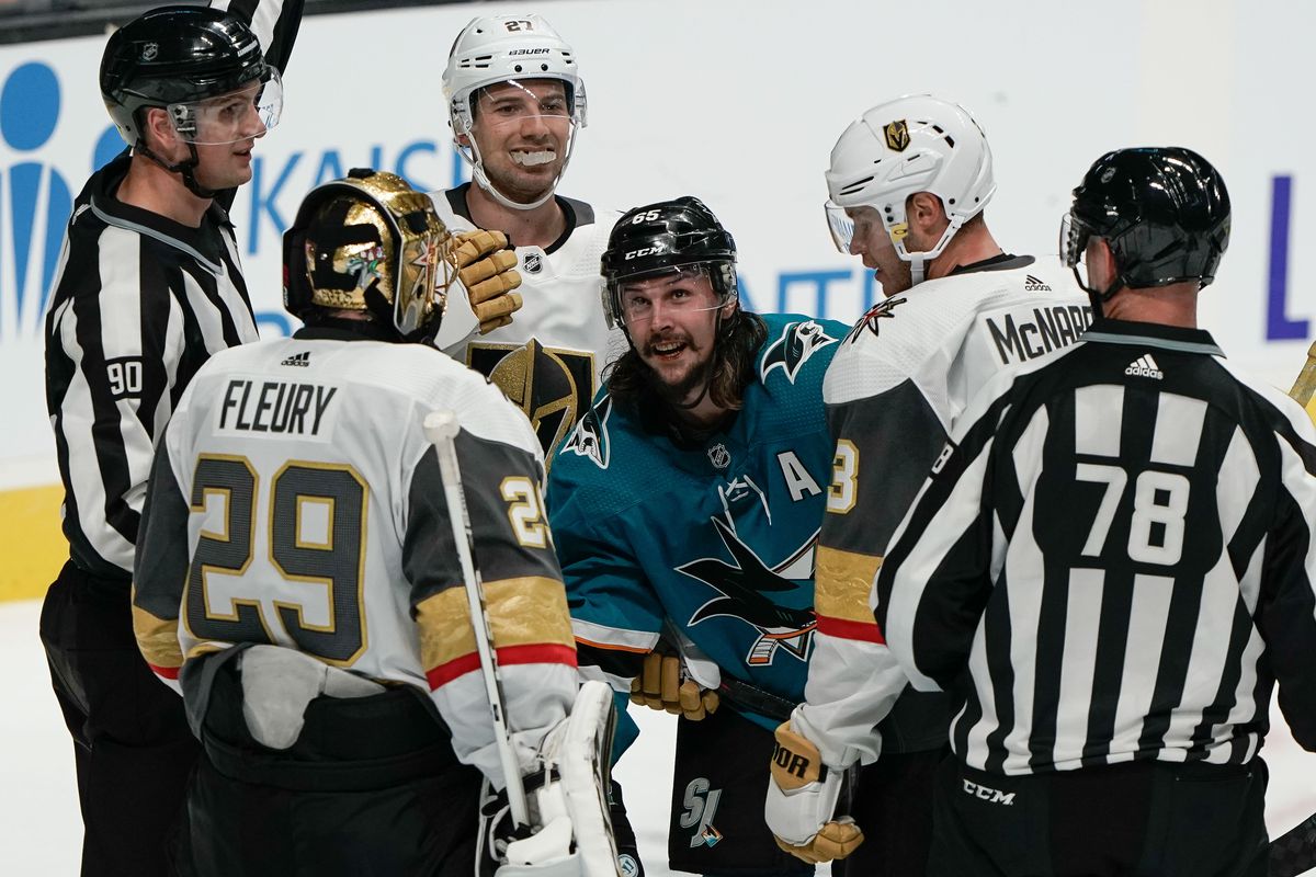 San Jose Sharks defenseman Erik Karlsson reacts after the whistle as he is surrounded by Vegas Golden Knights goaltender Marc-Andre Fleury, defenseman Shea Theodore and defenseman Brayden McNabb during the third period at SAP Center at San Jose.