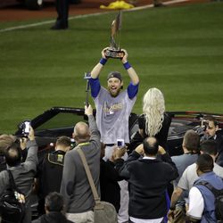 Chicago Cubs' Ben Zobrist celebrates with his MVP trophy after Game 7 of the Major League Baseball World Series against the Cleveland Indians Thursday, Nov. 3, 2016, in Cleveland. The Cubs won 8-7 in 10 innings to win the series 4-3. (AP Photo/Gene J. Puskar)