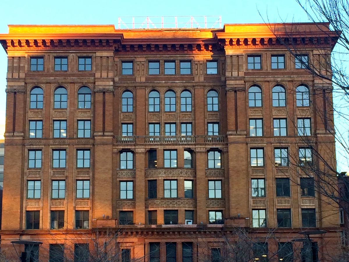The exterior of the Bourse Building in Philadelphia. The facade is brown brick with a flat roof and multiple windows.