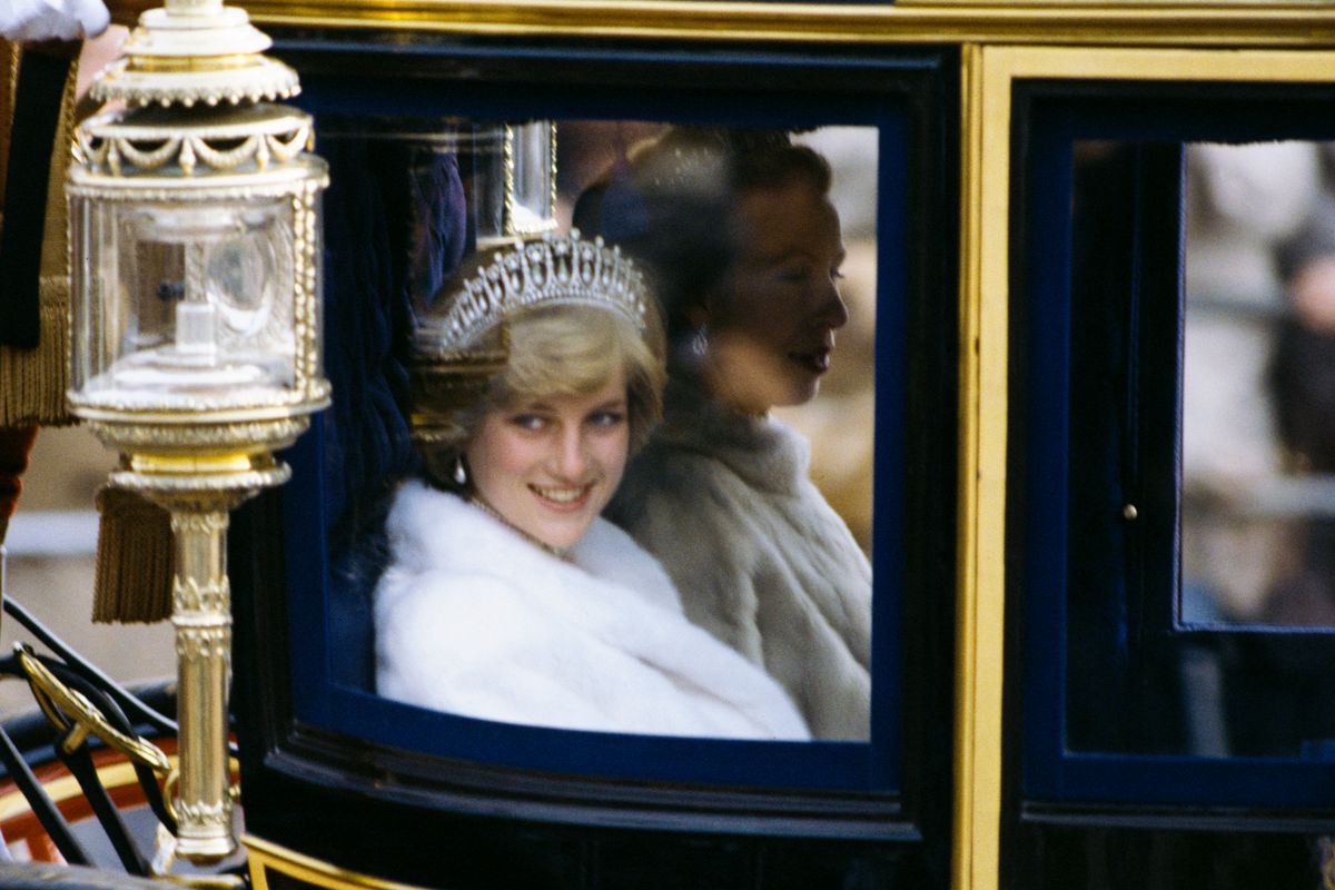 Diana, Princess of Wales —&nbsp;riding in the glass coach used on her wedding day 10 years years earlier — heads to the state Opening of Parliament in November 1981 in London, England. (Photo by Anwar Hussein)