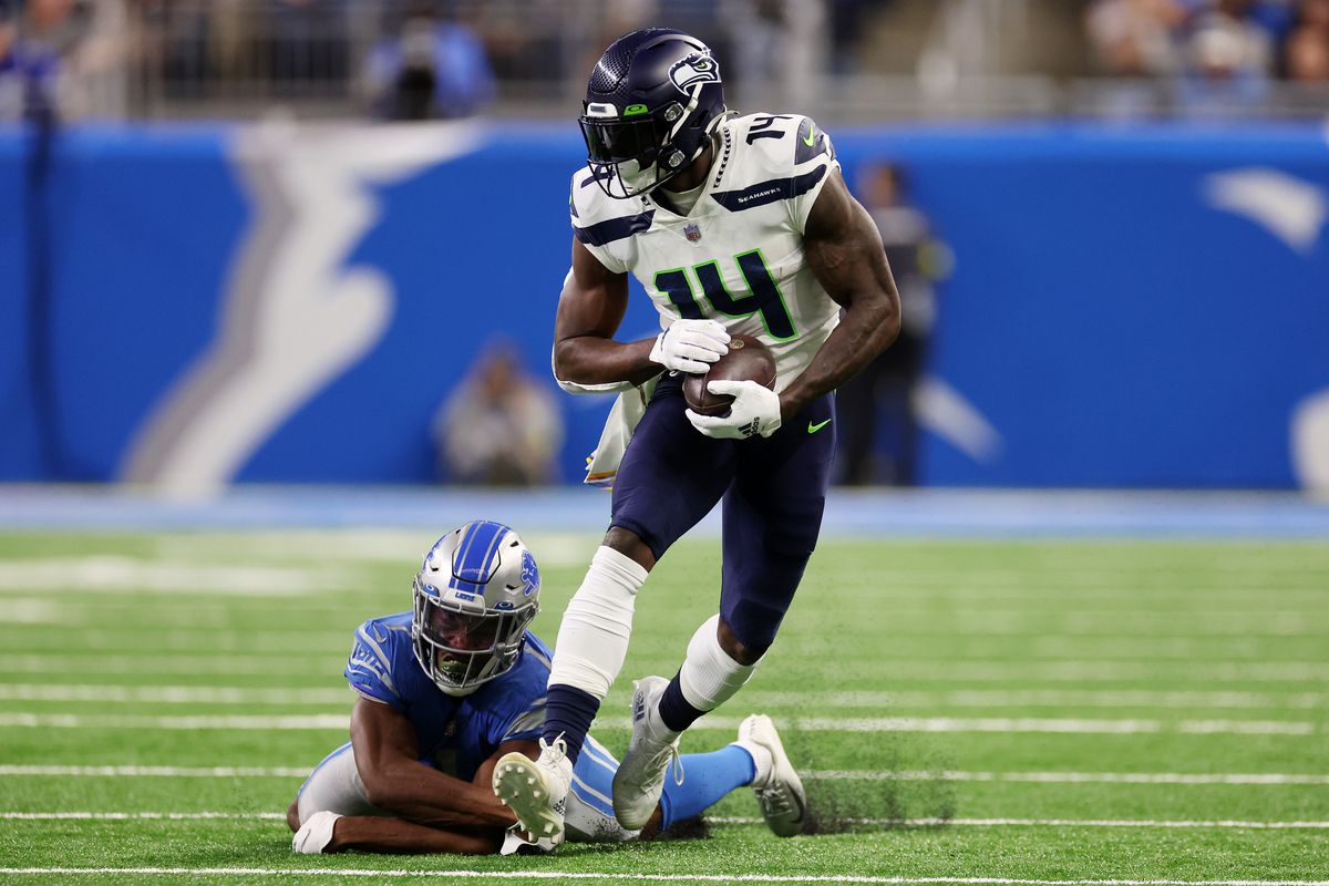 DK Metcalf #14 of the Seattle Seahawks runs with the ball during the second quarter against the Detroit Lions at Ford Field on October 02, 2022 in Detroit, Michigan.
