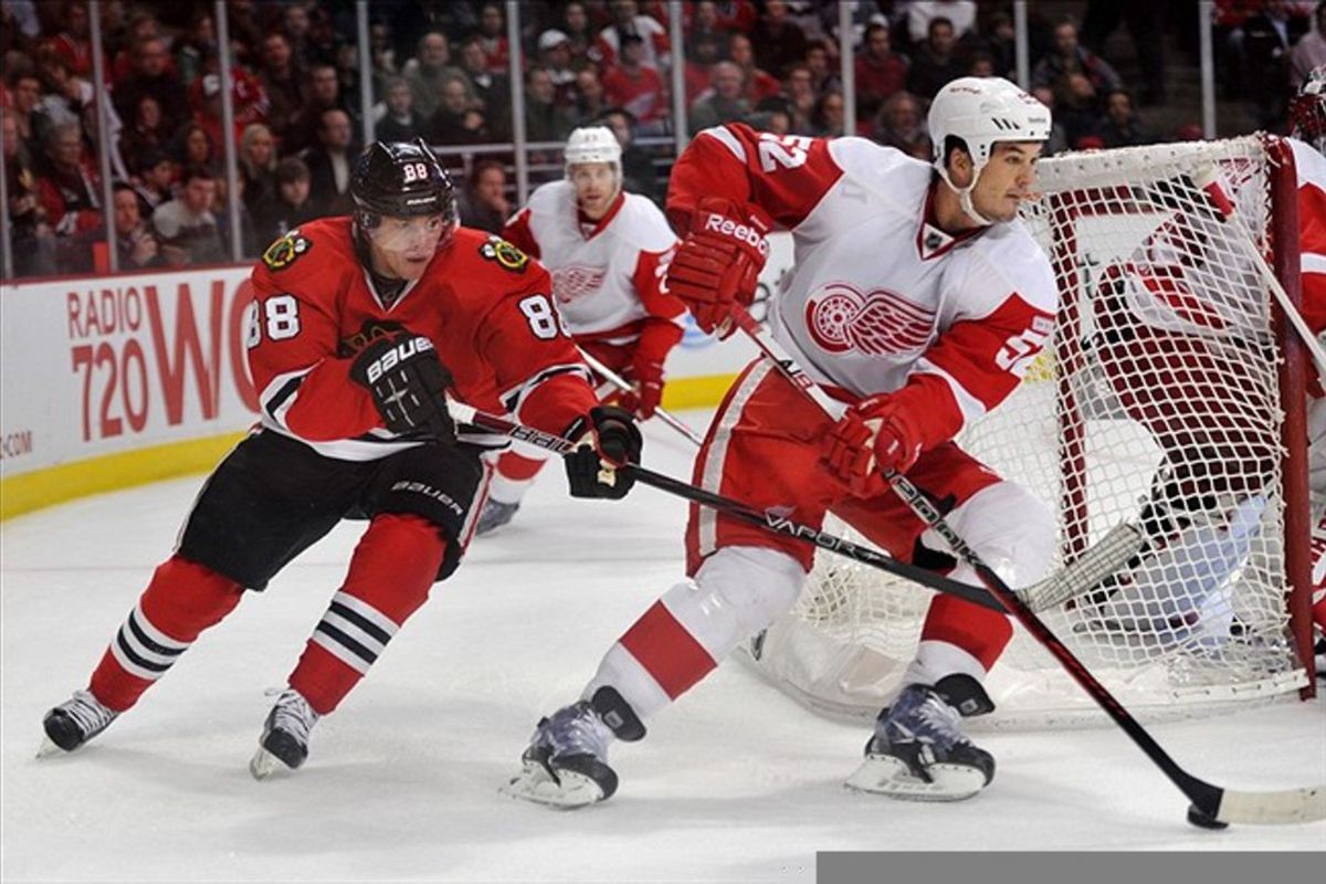 Feb 21, 2012; Chicago, IL, USA; Detroit Red Wings defenseman Jonathan Ericsson (52) moves the puck past Chicago Blackhawks right wing Patrick Kane (88) during the second period at the United Center. Mandatory Credit: Rob Grabowski-US PRESSWIRE