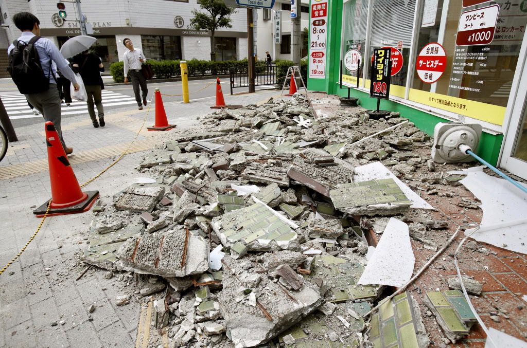 Debris of damaged walls are scattered following an earthquake, in Ibaraki, Osaka, Monday, June 18, 2018. A strong earthquake knocked over walls and set off scattered fires around the city of Osaka in western Japan on Monday morning. | Yosuke Mizuno/Kyodo 