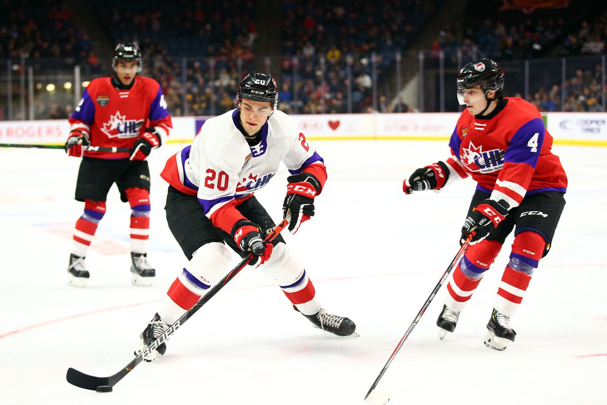 Brandon Coe #20 of Team White skates with the puck as Jamie Drysdale #44 of Team Red defends during the third period of the 2020 CHL/NHL Top Prospects Game at FirstOntario Centre on January 16, 2020 in Hamilton, Canada.