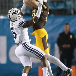 Brigham Young Cougars defensive back Dayan Lake (5) break sup a pass for Wyoming Cowboys wide receiver Jake Maulhardt (83) during the Poinsettia Bowl in San Diego on Wednesday, Dec. 21, 2016. BYU won 24-21.