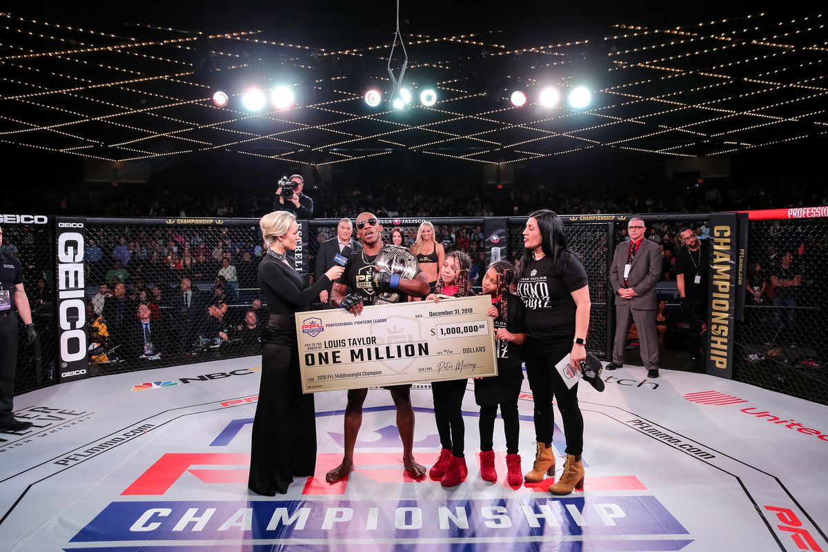 Louis Taylor accepts his $1 million check with his wife, Suzan and two daughters, Leila and Liyah on New Years Eve. (contributed photo/Professional Fighters League)
