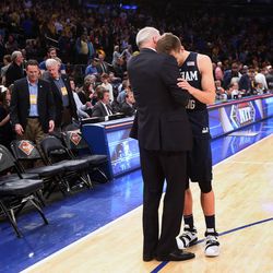 Brigham Young Cougars head coach Dave Rose hugs Brigham Young Cougars guard Kyle Collinsworth (5) after the BYU Cougars fall to Valparaiso 72-70 in NIT semifinal action at Madison Square Garden in New York City Tuesday, March 29, 2016.