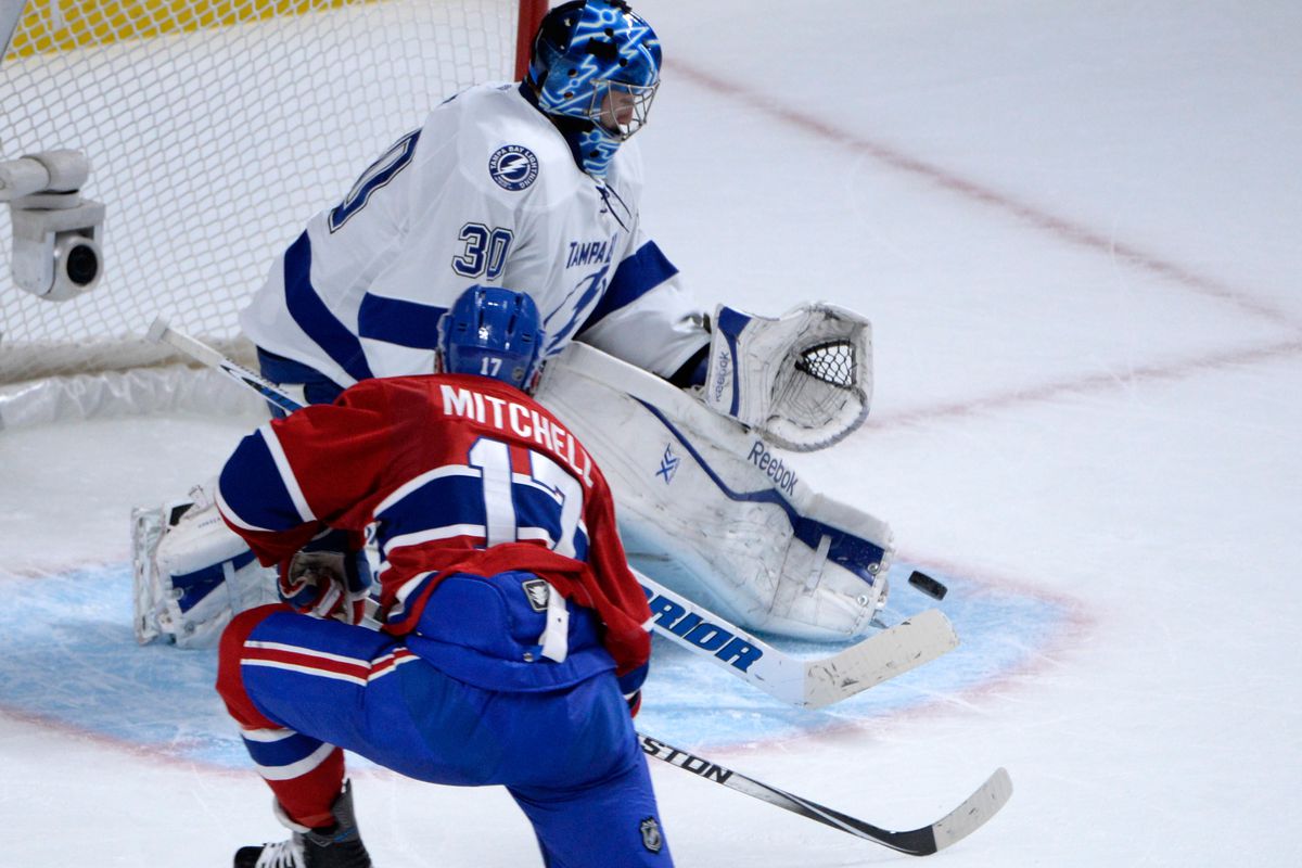 Tampa Bay Lightning goalie Ben Bishop (30) stops Montreal Canadiens forward Torrey Mitchell (17) during the first period in Game Two of the second round of the 2015 Stanley Cup Playoffs at the Bell Centre. 