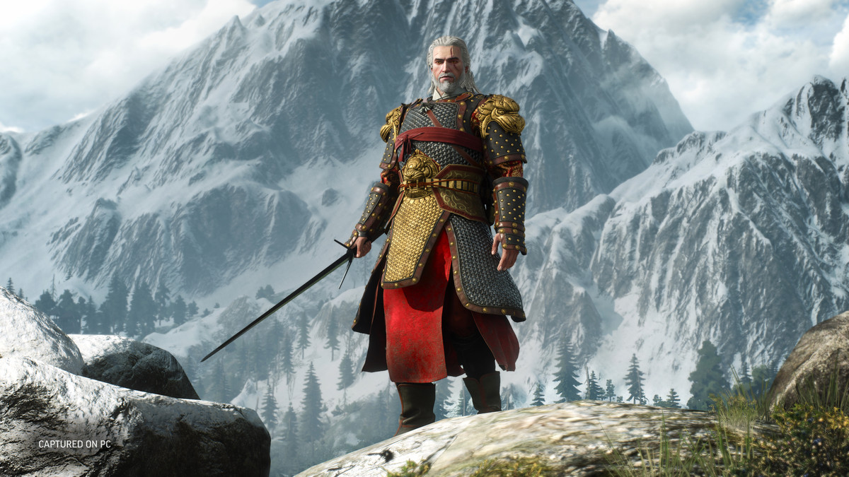 Geralt of Rivia wears the “Chinese armor” from The Witcher 3’s next-gen upgrade as he stands atop a mountain