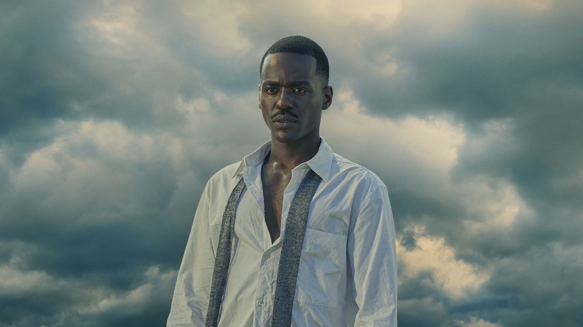 Ncuti Gatwa stands against a cloudy sky in a dress shirt with a tie undone as the Fifteenth Doctor in the final Doctor Who 60th anniversary special.