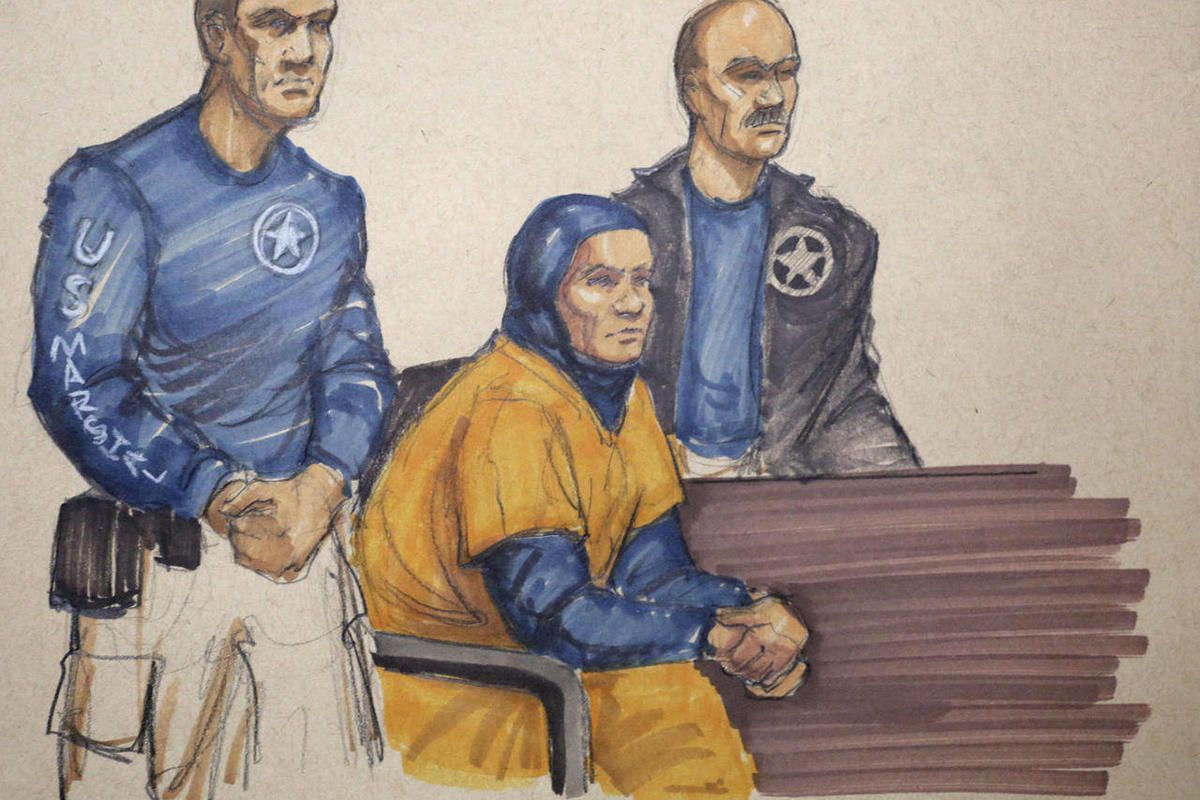 In this Monday, Feb. 9, 2015 courtroom sketch, Mediha Medy Salkicevic, center, appears in federal court in Chicago. Salkiceveic is accused with five other Bosnian immigrants of sending money and equipment to extremist groups in Syria. Salkiceveic appeared