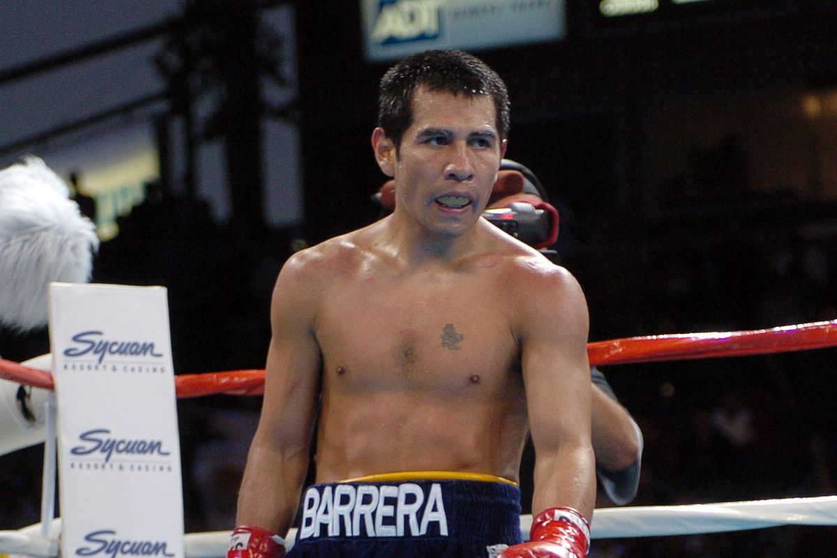 Marco Antonio Barrera walks to a neutral corner as Paulie Ayala lies on the canvas as referee Paul Russell intervenes to stop the bout and Barrera claimed the WBC Continental Americas Middleweight Championship by TKO at the Home Depot Center June 19, 2004.