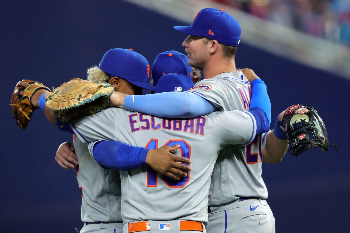 Francisco Lindor #12, Eduardo Escobar #10 and Pete Alonso #20 of the New York Mets celebrate their Opening Day win against the Miami Marlins at loanDepot park on Thursday, March 30, 2023 in Miami, Florida.