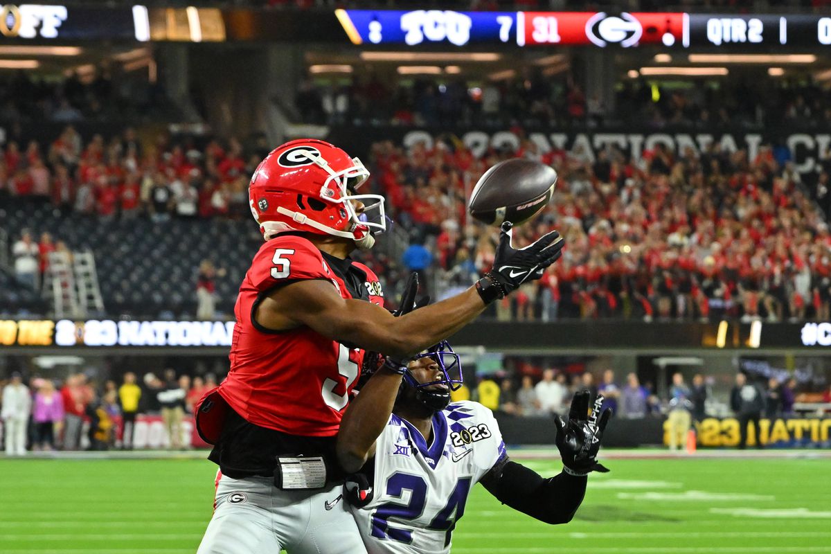 Georgia Bulldogs wide receiver Adonai Mitchell (5) catches a touchdown pass over TCU Horned Frogs cornerback Josh Newton (24) during the first half in the CFP national championship game at SoFi Stadium. Mandatory Credit: Jayne Kamin-Oncea