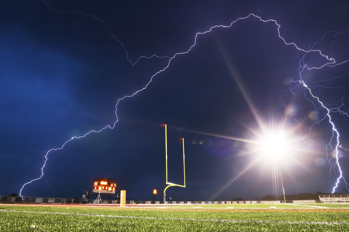 Lightning flashes at halftime as Lone Peak and Herriman open the 2018-19 football season at Lone Peak on Friday, Aug. 17, 2018. The game is delayed at the half for weather.
