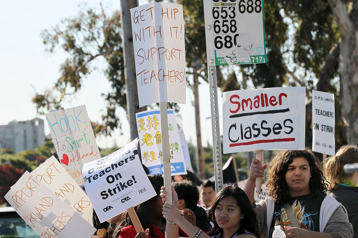 Oakland teachers and students protest during a one-day strike outside of Oakland High School on April 29, 2010 in Oakland, California.