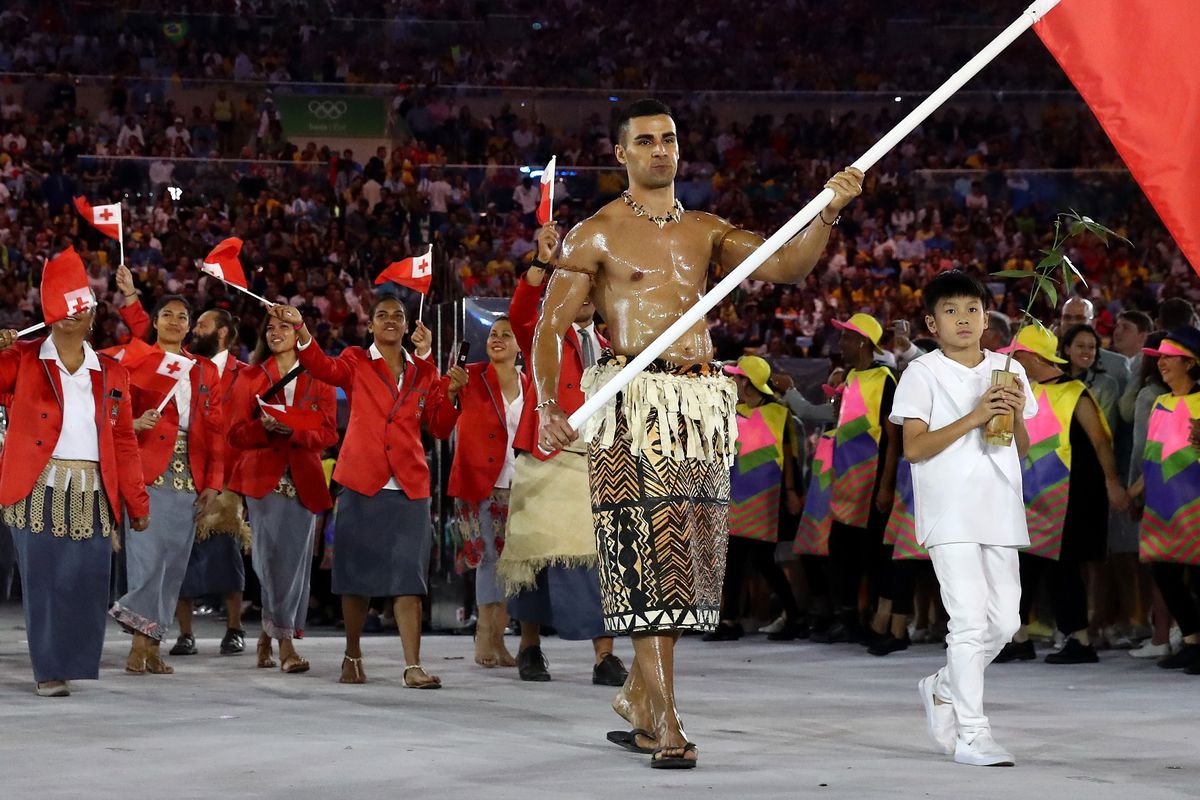 Pita Taufatofua of Tonga carries the flag during the Opening Ceremony of the Rio 2016 Olympic Games.