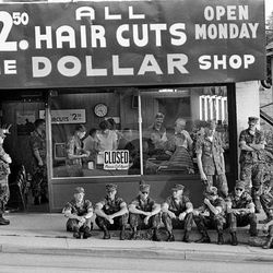 Marines line up for a cut-rate haircut.