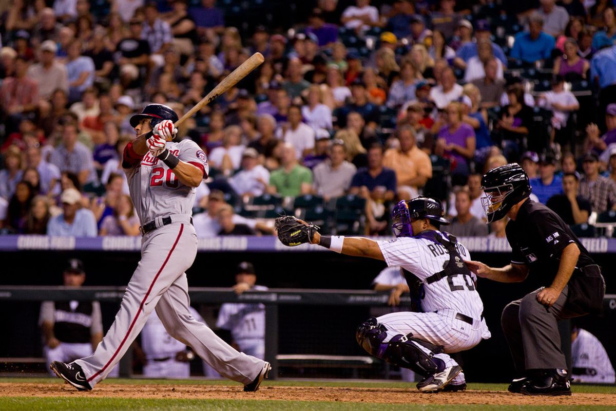 DENVER, CO - JUNE 27:  Ian Desmond #20 of the Washington Nationals follows through on a double during the seventh inning against the Colorado Rockies at Coors Field on June 27, 2012 in Denver, Colorado.  (Photo by Justin Edmonds/Getty Images)