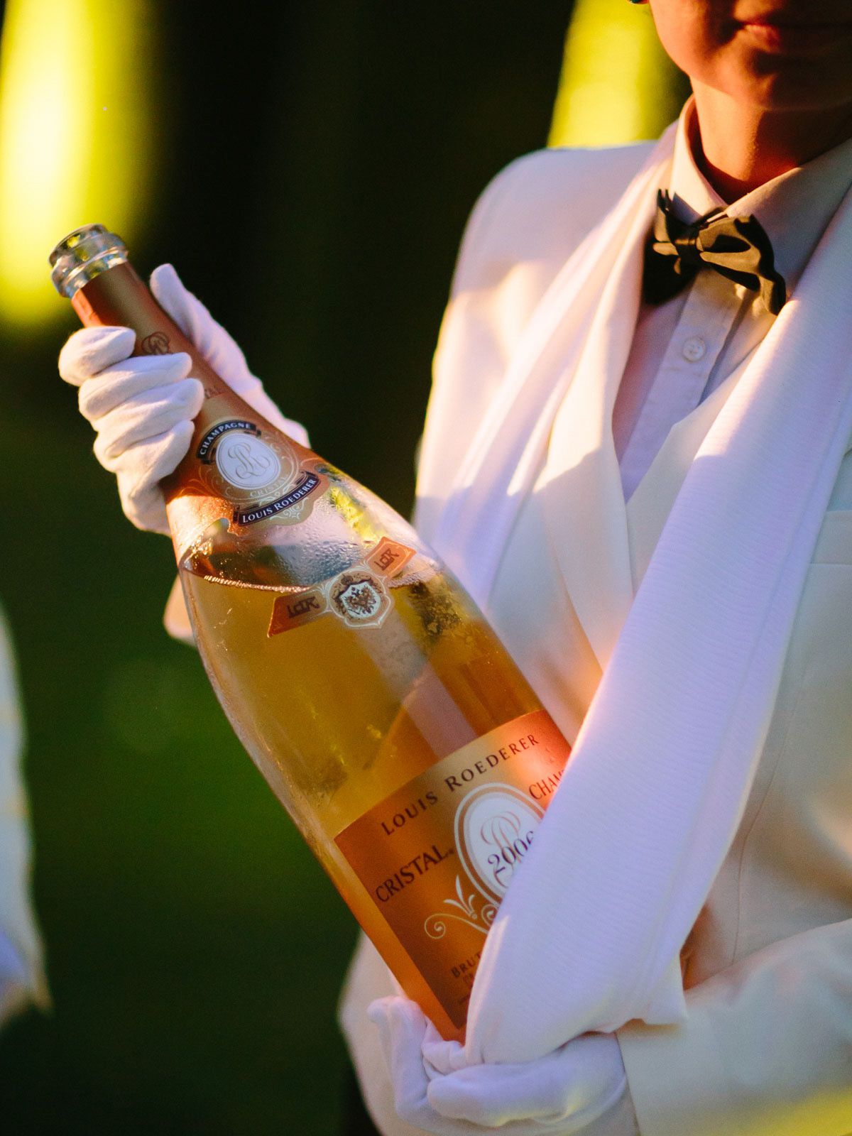 A waiter serves a Jeroboam of Cristal Champagne at a ‘Great Gatsby’ welcome party in Florence.