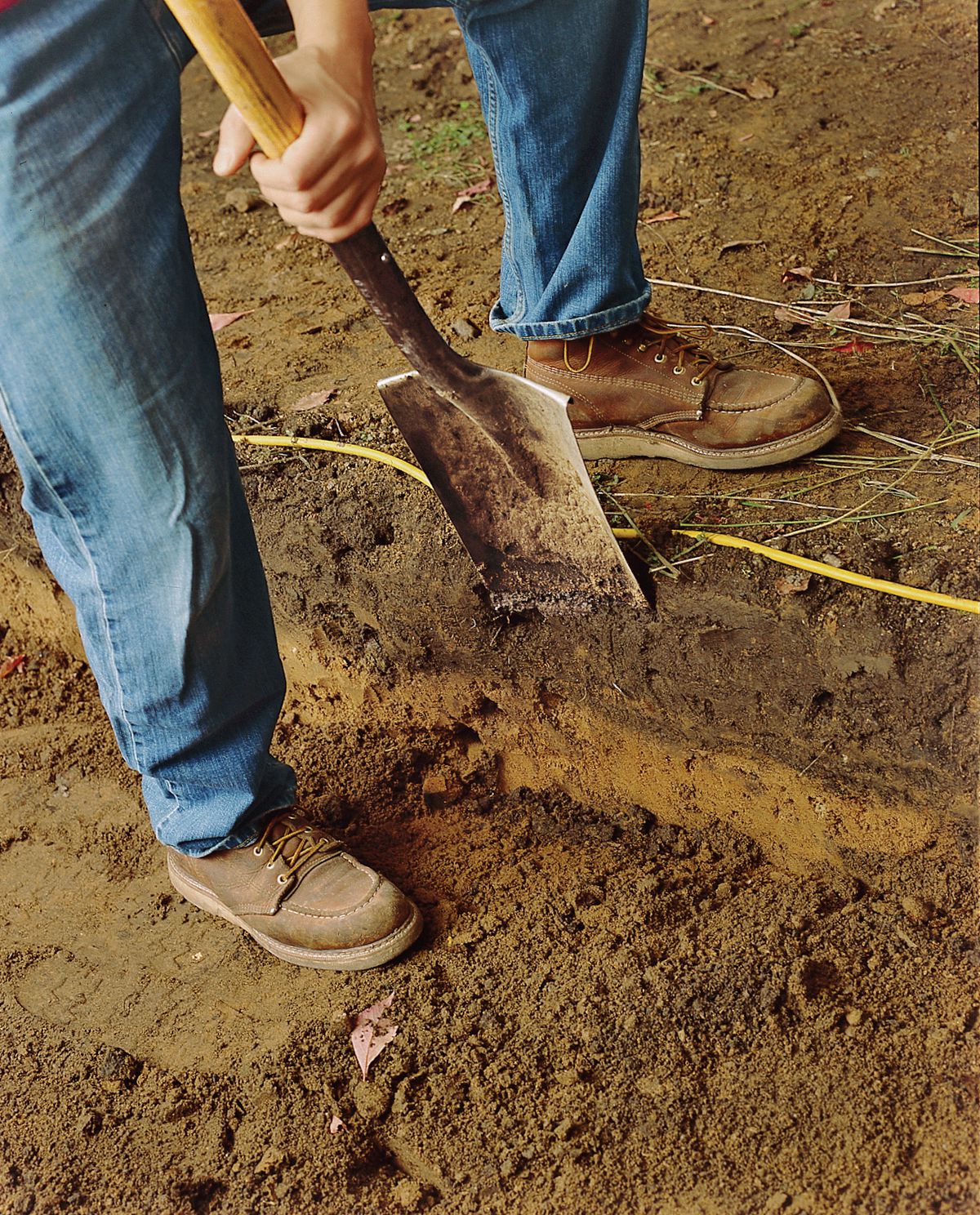 Man Digging Soil With Spade To Make Brick Path