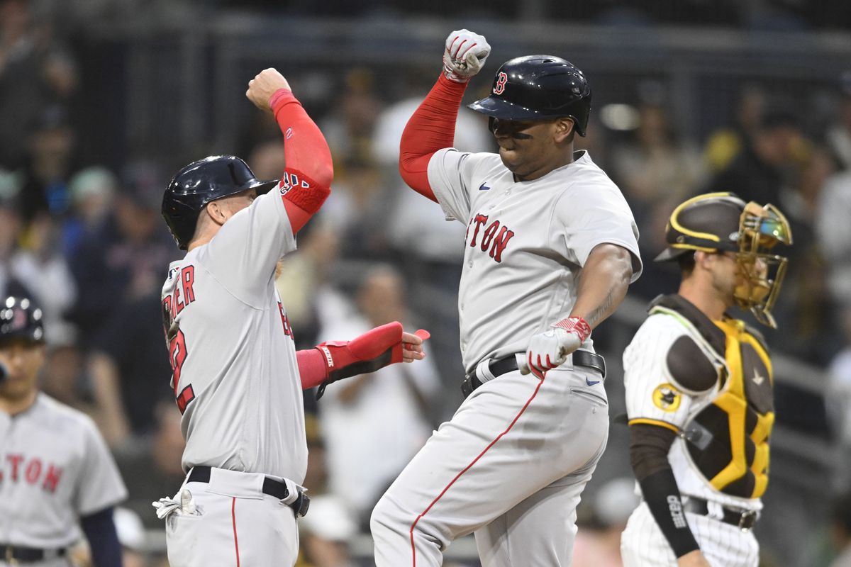 Rafael Devers #11 (R) of the Boston Red Sox is congratulated by Justin Turner #2 after hitting a three-run home run during the third inning of a baseball game against the San Diego Padres at Petco Park on May 19, 2023 in San Diego, California.