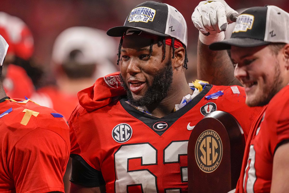 Georgia Bulldogs offensive lineman Sedrick Van Pran with the trophy after Georgia defeated the LSU Tigers in the SEC Championship game at Mercedes-Benz Stadium.