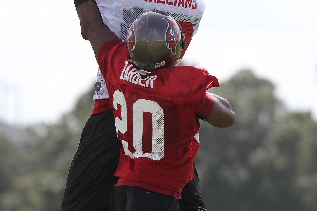 July 27, 2012; Tampa, FL, USA;  Tampa Bay Buccaneers wide receiver Mike Williams (19) catches the ball over defensive back Ronde Barber (20) during training camp at One Buc Place. Mandatory Credit: Kim Klement-US PRESSWIRE