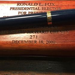 Wooden plaque commemorating 2000 Electoral College electing George W. Bush and Dick Cheney, and the pen Ron Fox used to sign his ballot.