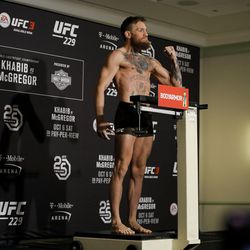 Conor McGregor poses after making weight at UFC 229 weigh-ins.