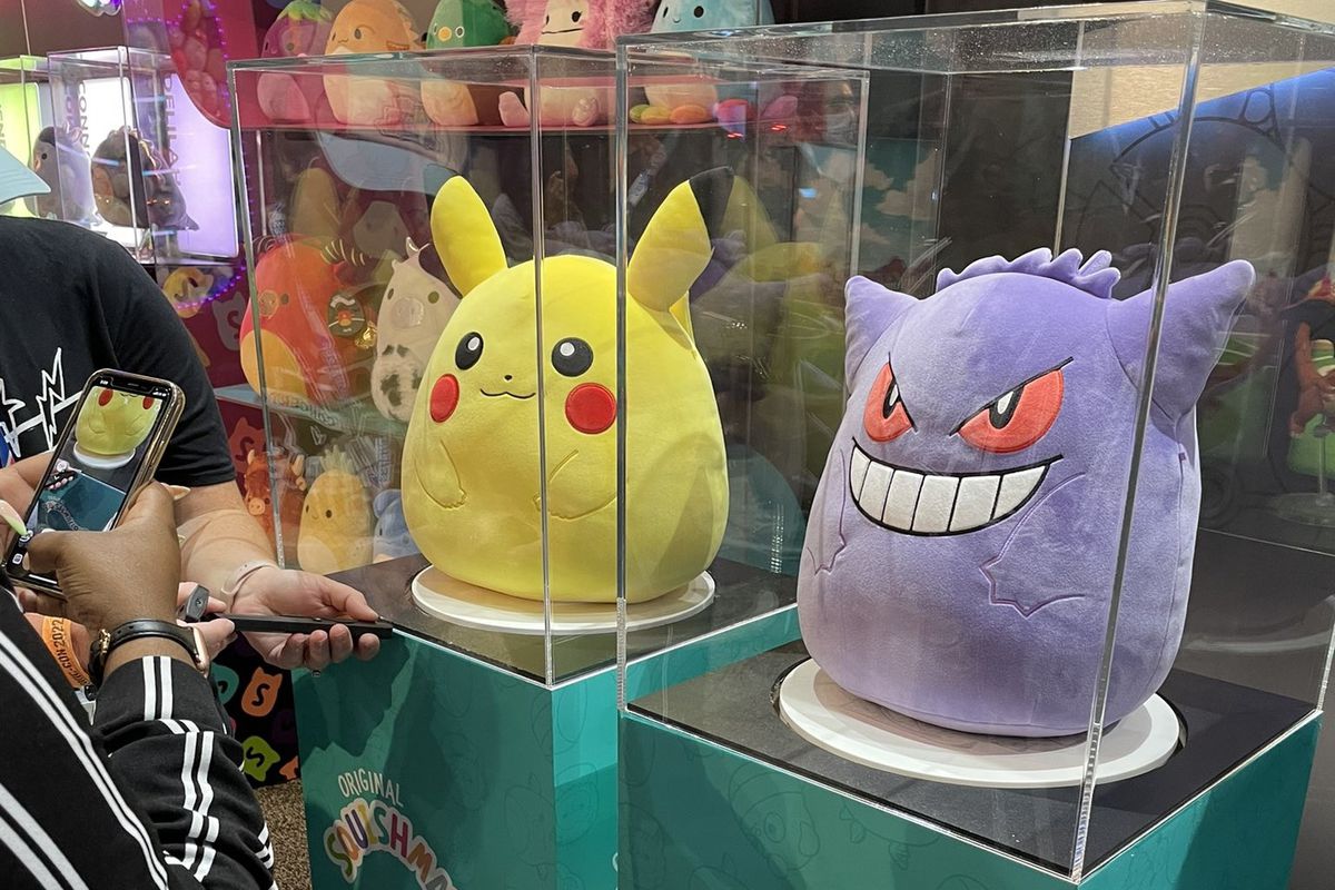 pikachu and gengar squishmallows at sdcc 2022, behind glass boxes
