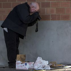 A forensics photographer documents contents of a package after it was detonated outside the mail operations center of The Church of Jesus Christ of Latter-day Saints, 48 S. 400 East, in Salt Lake City on Thursday, Dec. 29, 2016. The package was considered suspicious after the bomb squad X-rayed it and discovered electronic items inside.