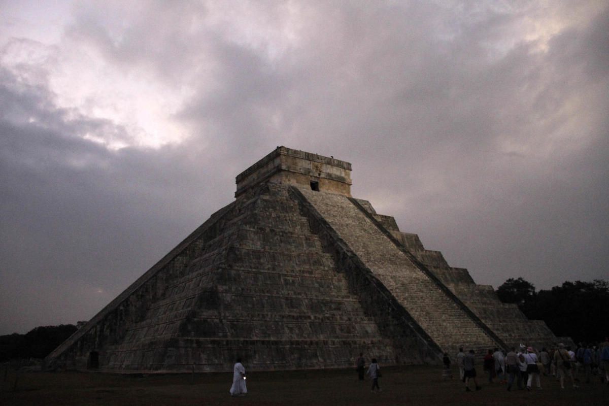 FILE - In this Dec. 21, 2012 file photo, people gather in front of the Kukulkan temple in Chichen Itza, Mexico. Mexican experts said Wednesday, Nov. 16, 2016 they have discovered what may be the original structure at the pyramid of Kukulkan at the Mayan r