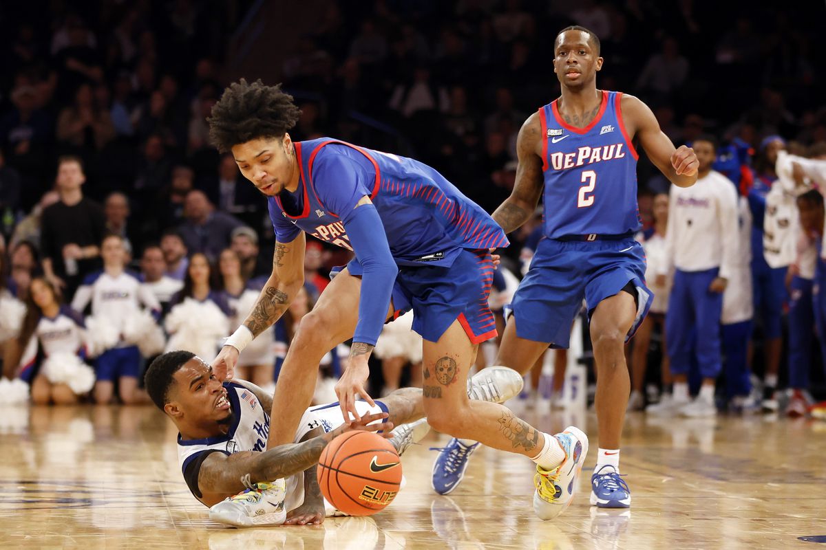 Al-Amir Dawes of the Seton Hall Pirates and Caleb Murphy of the DePaul Blue Demons battle for a loose ball during the second half in the first round of the Big East Basketball Tournament at Madison Square Garden on March 08, 2023 in New York City. The DePaul Blue Demons won 66-65.