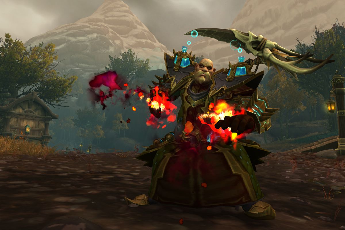 World of Warcraft - a bulky Kul Tiran male in warlock gear powers up a fire spell with his hands.
