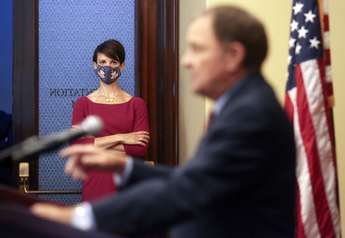 State epidemiologist Dr. Angela Dunn listens as Gov. Gary Herbert speaks during a COVID-19 press conference at the Capitol in Salt Lake City on Thursday, Oct. 8, 2020.