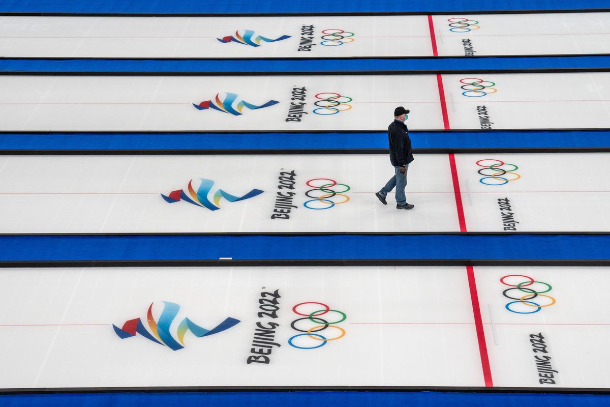 A worker walks on the curling sheets at the National Aquatic Centre on January 30, 2022 in Beijing, China. With less than one week to go until the opening ceremony of the Beijing 2022 Winter Olympics, Chinese authorities are making final preparations to try and ensure a successful Games amid the continuing Covid-19 coronavirus pandemic.