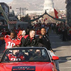 Utah linebacker Stevenson Sylvester, left, head coach Kyle Whittingham and quarterback Brian Johnson ride down State Street during the parade for the U. football team Friday. Ute fans converged on downtown Salt Lake City to celebrate the Utes' Sugar Bowl win and the team's perfect 13-0 season. 