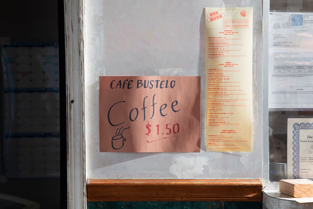 Two signs, one that says Cafe Bustelo Coffee $1.50 and the other a yellow menu with red text.