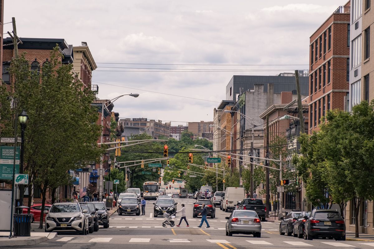 People wearing the protective mask walk on the street as the city reopens from the coronavirus lockdown on June 15, 2020 in Hoboken, New Jersey.