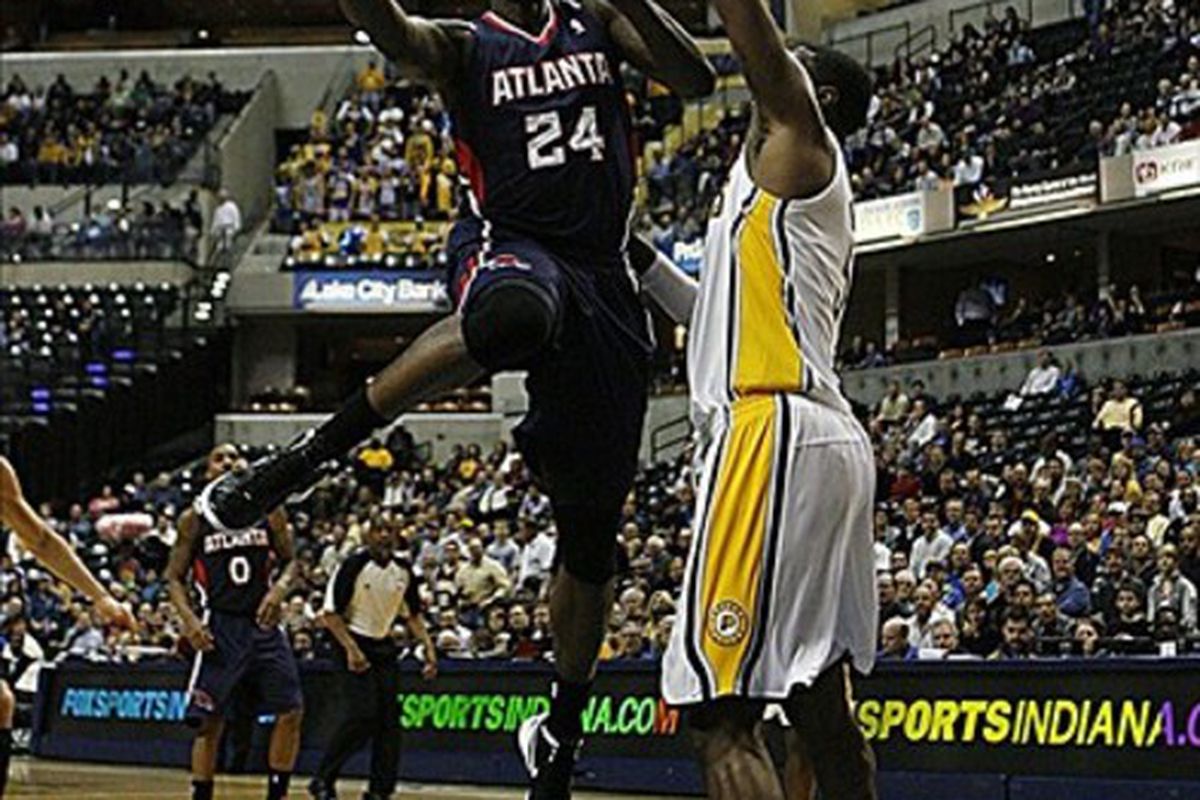 Mar 6, 2012; Indianapolis, IN, USA; Atlanta Hawks forward Marvin Williams (24) takes a shot in the lane against Indiana Pacers center Roy Hibbert (55) at Bankers Life Fieldhouse.  Mandatory Credit: Brian Spurlock-US PRESSWIRE
