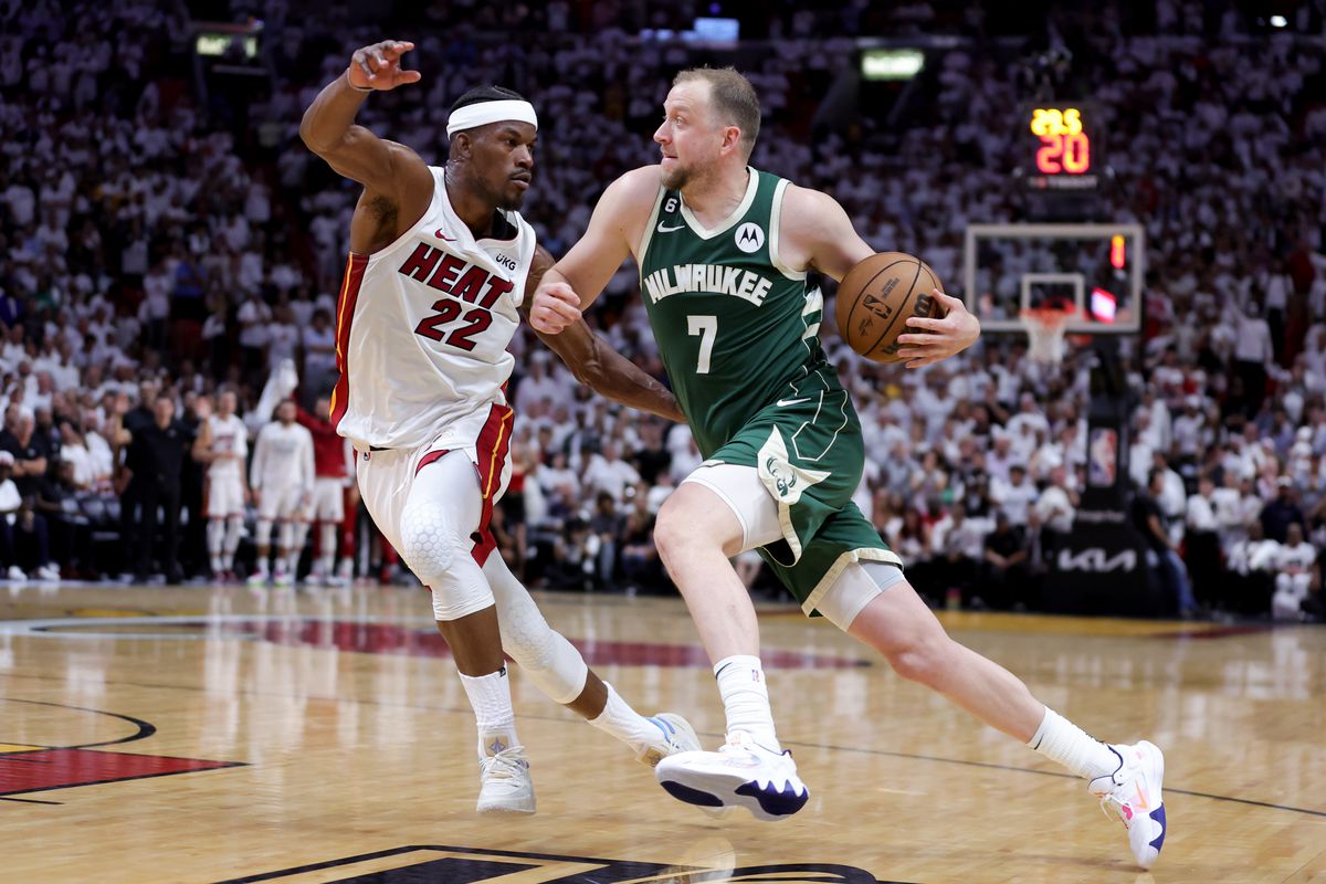 Joe Ingles #7 of the Milwaukee Bucks drives against Jimmy Butler #22 of the Miami Heat during the fourth quarter in Game Four of the Eastern Conference First Round Playoffs at Kaseya Center on April 24, 2023 in Miami, Florida. NOTE TO USER: User expressly acknowledges and agrees that, by downloading and or using this photograph, User is consenting to the terms and conditions of the Getty Images License Agreement.