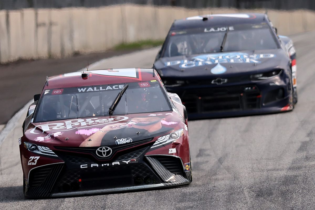 Bubba Wallace, driver of the #23 Dr. Pepper Toyota, and Corey LaJoie, driver of the #7 Diamond Creek Water Chevrolet, race during the NASCAR Cup Series Jockey Made in America 250 Presented by Kwik Trip at Road America on July 04, 2021 in Elkhart Lake, Wisconsin.