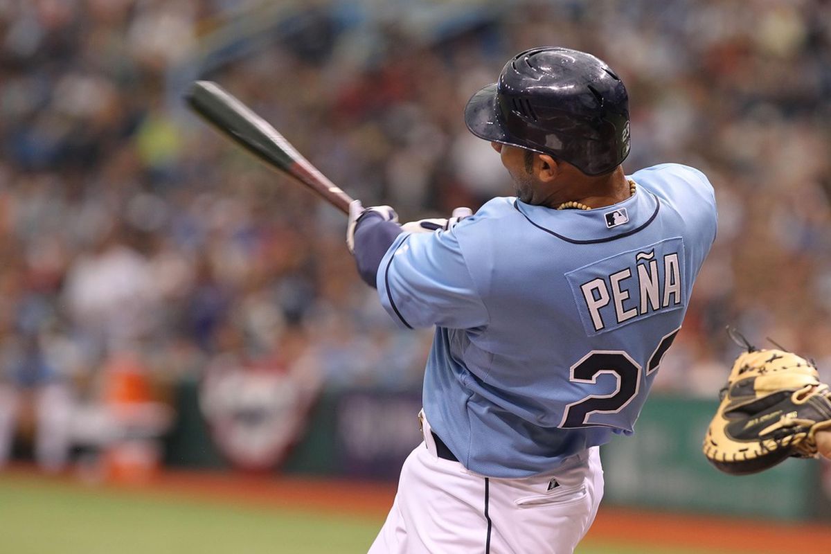 April 8, 2012; St. Petersburg, FL, USA; Tampa Bay Rays first baseman Carlos Pena (23) hits a home run in the third inning against the New York Yankees at Tropicana Field. Mandatory Credit: Kim Klement-US PRESSWIRE