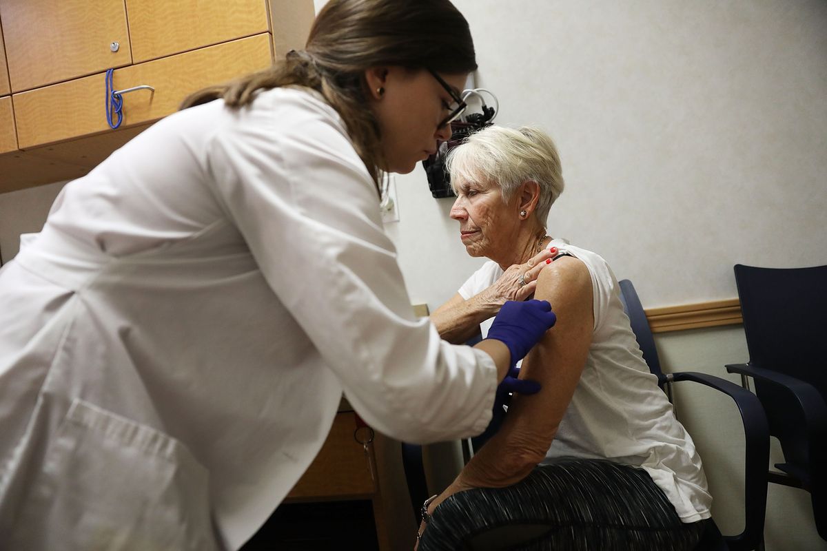 Luanne Boiko receives an influenza vaccination from nurse practitioner at the CVS Pharmacy store’s MinuteClinic on October 4, 2018 in Miami, Florida.