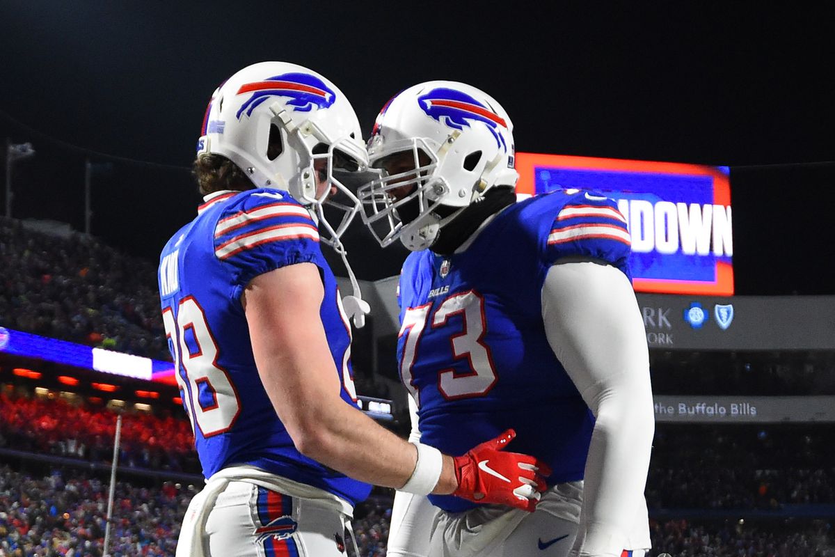 Buffalo Bills tight end Dawson Knox (88) celebrates with offensive tackle Dion Dawkins (73) after scoring a touchdown in the first quarter against the New England Patriots in the AFC Wild Card playoff game at Highmark Stadium.