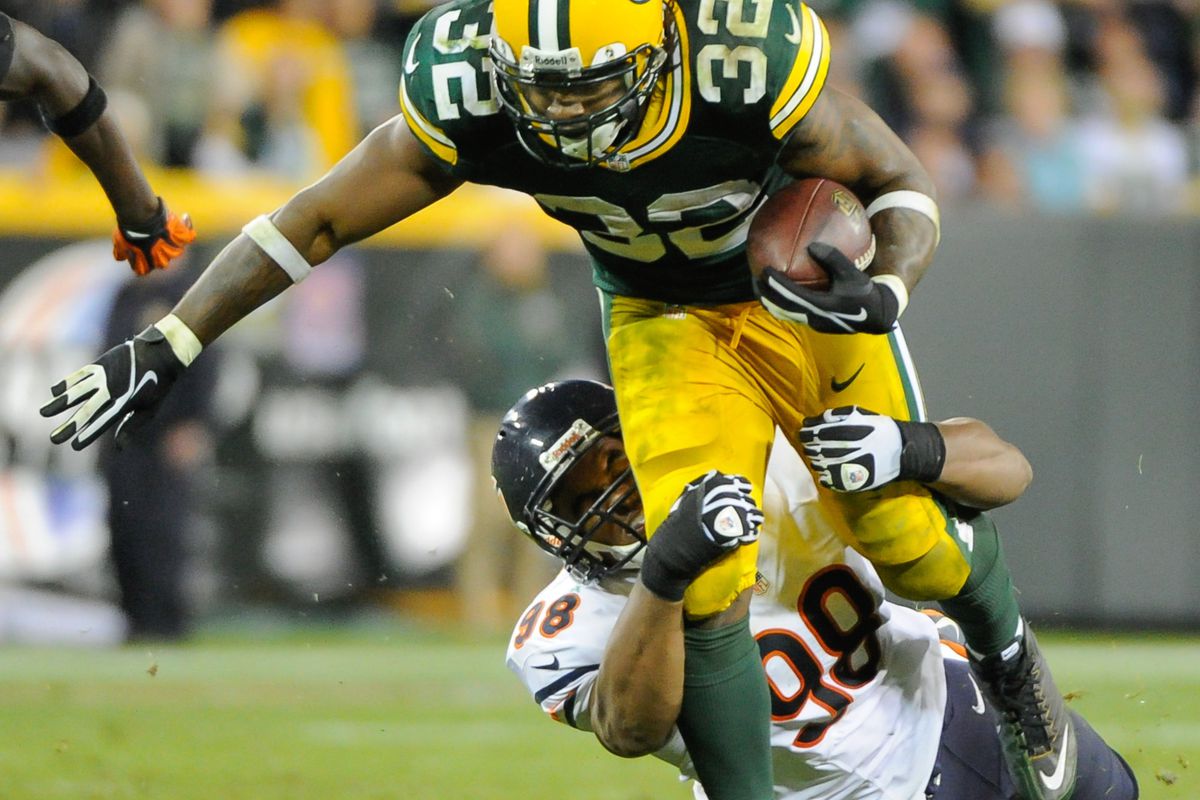 Sept 13, 2012; Green Bay, WI, USA;   Green Bay Packers running back Cedric Benson (32) tries to break a tackle by Chicago Bears defensive end Corey Wootton (98) during the fourth quarter at Lambeau Field.  Mandatory Credit: Benny Sieu-US PRESSWIRE